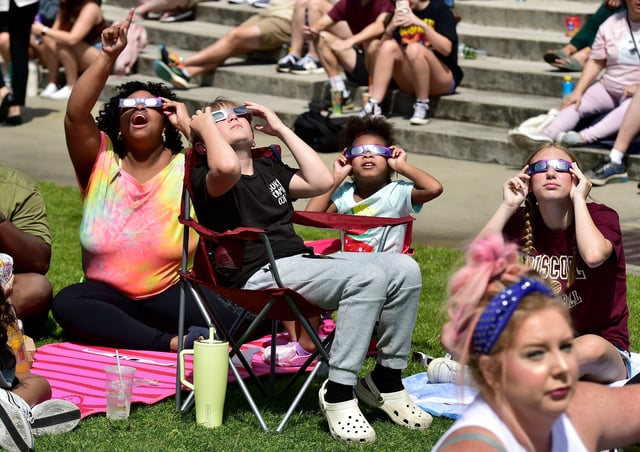 Spectators watched as the partial solar eclipse reached it's peak coverage at the viewing event at the University of North Florida Monday, April 8, 2024.