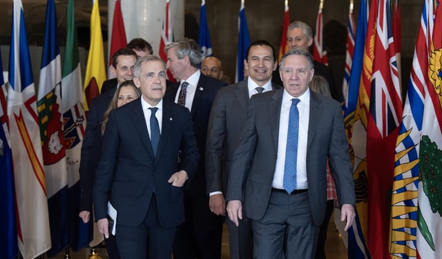 Prime Minister Mark Carney, front left, walks alongside Francois Legault, Premier of Quebec,  as they are joined by first ministers as they arrives to take part in the First Minister Meeting at the National War Museum in Ottawa on Friday, March 21, 2025. THE CANADIAN PRESS/Adrian Wyld