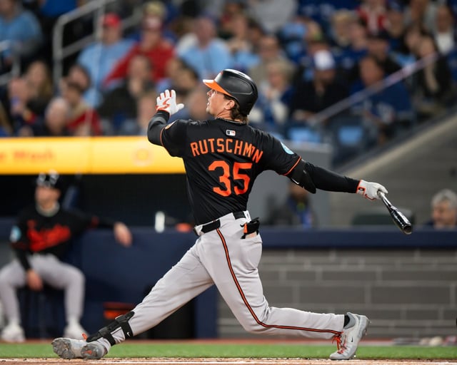 Baltimore Orioles catcher Adley Rutschman (35) hits a home run during theagainst the Toronto Blue Jays in an opening-day baseball game against the Baltimore Orioles in Toronto, Thursday, March 27, 2025. (Christopher Katsarov/The Canadian Press via AP)