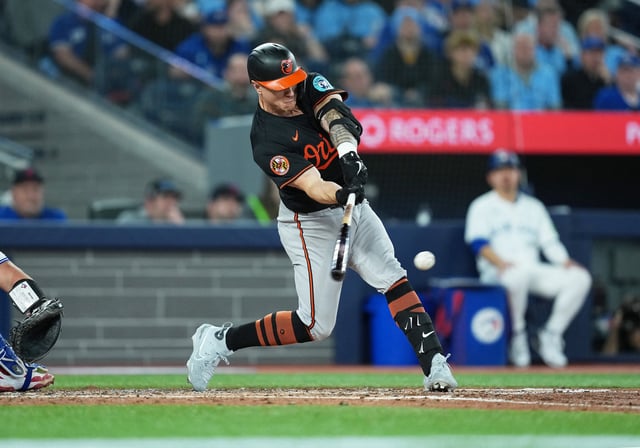 Mar 27, 2025; Toronto, Ontario, CAN; Baltimore Orioles right ielder Tyler O'Neill (9) hits a single against the Toronto Blue Jays during the fifth inning at Rogers Centre. Mandatory Credit: Nick Turchiaro-Imagn Images