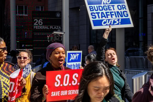 People shout slogans during a rally in support of federal workers outside the 26 Federal Plaza, a federal office building in New York City, U.S., March 25, 2025.