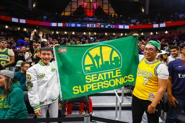 Fans hold a flag for the Seattle Supersonics during the fourth quarter of a game between the Utah Jazz and LA Clippers at Climate Pledge Arena.