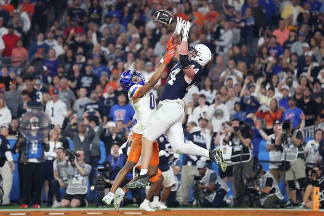 Tyler Warren #44 of the Penn State Nittany Lions catches a pass for a touchdown over Ty Benefield #0 of the Boise State Broncos during the third quarter in the 2024 Vrbo Fiesta Bowl.