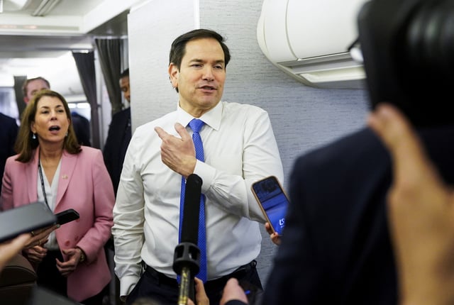 U.S. Secretary of State Marco Rubio speaks with reporters on his plane while flying from Suriname en route to Miami, Florida, March 27, 2025. REUTERS/Nathan Howard/Pool/File photo