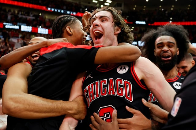Australian Josh Giddey, center, celebrates with teammates after hitting a half-court shot at the final buzzer to lift the Chicago Bulls over the visiting Los Angeles Lakers