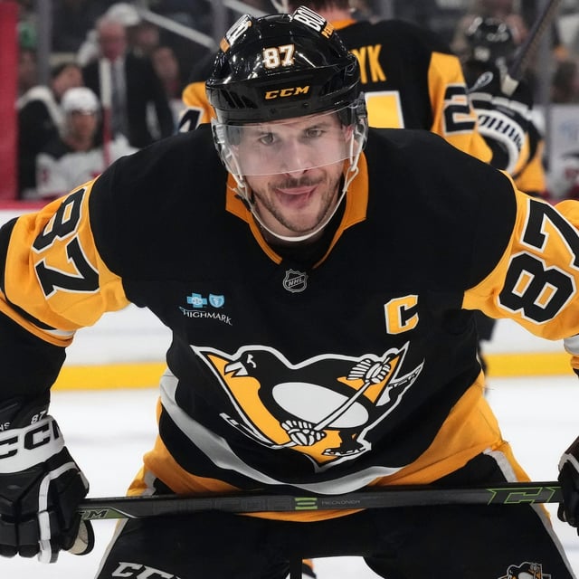 Pittsburgh Penguins' Sidney Crosby prepares to take a face-off during the second period of an NHL hockey game against the New Jersey Devils in Pittsburgh, Saturday, March 15, 2025. (AP Photo/Gene J. Puskar)