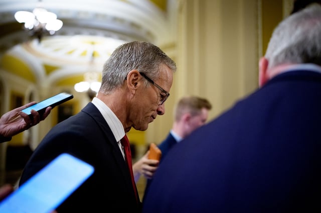 Senate Majority Leader John Thune takes a question from a reporter as he walks off the Senate floor at the Capitol on March 24, 2025 in Washington, DC.