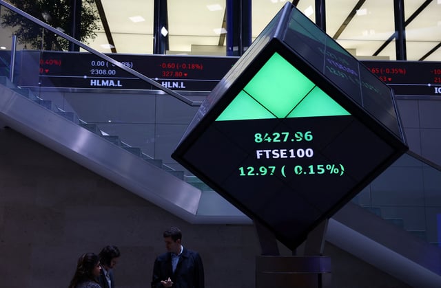 People stand in the lobby of the London Stock Exchange in London, Britain, May 14, 2024. REUTERS/Hannah McKay/File Photo