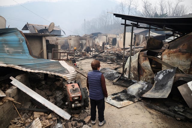 Kun Yeong-nam, 72, looks around her burnt house, in which she lived in for 52 years, after a wildfire devastated the area in Uiseong, South Korea March 27, 2025.REUTERS/Kim Hong-Ji/File Photo