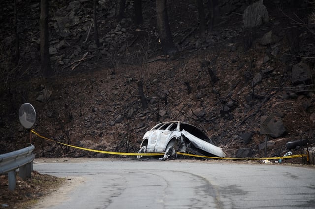 A burnt vehicle, in which a village leader Kwon and his wife were found dead while they were on their way back to their village to rescue other people during a wildfire, lies on the side of a road, in Yeongyang, South Korea, March 28, 2025. REUTERS/Kim Hong-Ji