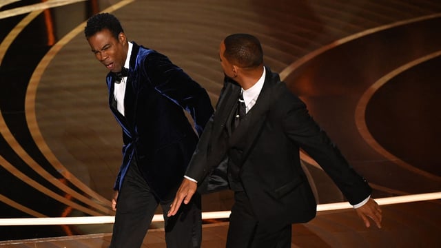 In this file photo taken on March 27, 2022, Will Smith (R) slaps Chris Rock onstage during the 94th Oscars at the Dolby Theatre in Hollywood, California. (Photo by Robyn Beck / AFP)