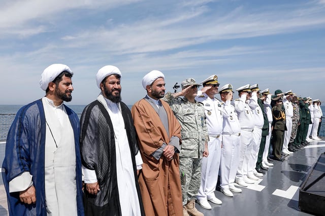 This handout photo made available by the Iranian Army Office on March 12, 2025 shows local officials and navy personnel attending a joint Iranian-Russian-Chinese military drill in the Gulf of Oman.