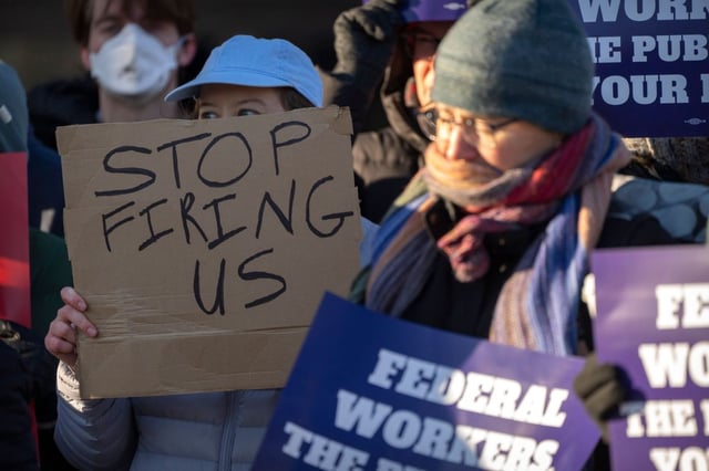 Demonstrators rally in support of federal workers outside of the Department of Health and Human Services in Washington recently.  (AP file/Mark Schiefelbein)