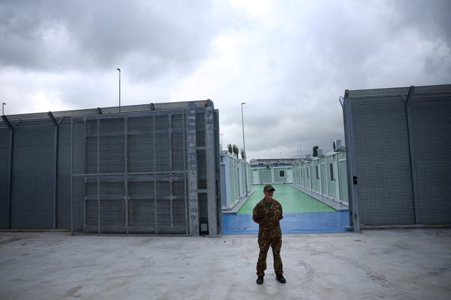 A member of Italian Army stands at a camp for illegal migrants in Gjader, Albania October 11, 2024. REUTERS/Florion Goga/File Photo