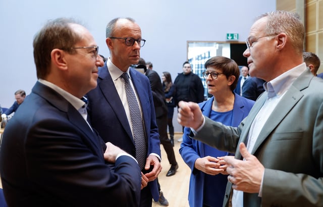 Parliamentary Group Leader of the Bavarian conservative Christian Social Union (CSU) party Alexander Dobrindt, the leader of Germany's Christian Democratic Union (CDU) Friedrich Merz and the co-leader of the Social Democratic Party (SPD) Saskia Esken talk as they arrive to meet for talks on forming a coalition government at the SPD headquarters in the Willy-Brandt-Haus in Berlin on March 28, 2025.     ODD ANDERSEN/Pool via REUTERS