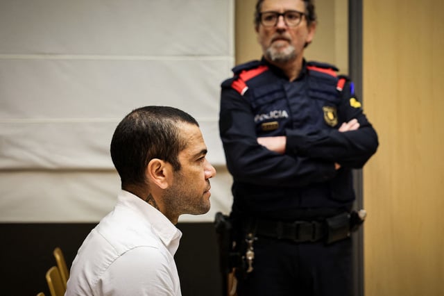 TOPSHOT - Brazilian footballer Dani Alves looks on at the start of his trial at the High Court of Justice of Catalonia in Barcelona, on February 5, 2024. Brazilian footballer Dani Alves, a former star at Barca and PSG, goes on trial in Barcelona accused of raping a woman in a local nightclub. Prosecutors are asking for a nine-year prison sentence, followed by 10 years of conditional liberty. They are also asking he pay 150,000 euros ($162,000) in compensation to the woman. (Photo by Jordi BORRAS / POOL / AFP) (Photo by JORDI BORRAS/POOL/AFP via Getty Images)