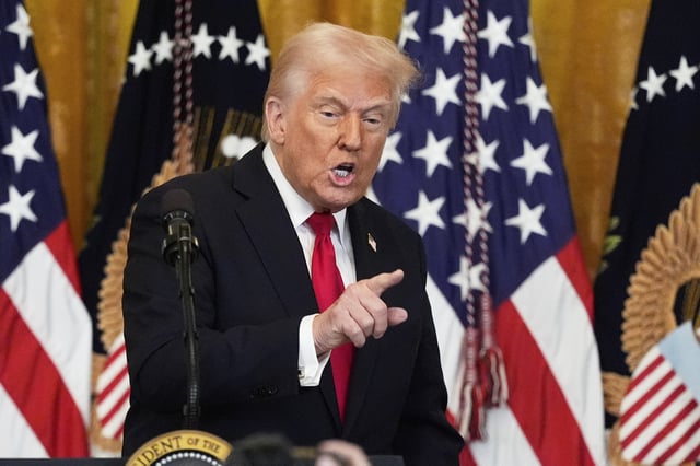 President Donald Trump gestures after speaking at a reception celebrating Women's History Month in the East Room of the White House, Wednesday, March 26, 2025, in Washington. (AP Photo/Mark Schiefelbein)