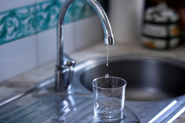 Water drips from a faucet.
