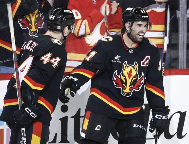 Calgary Flames' Nazem Kadri, right, celebrates his goal with teammate Joel Hanley during second period NHL hockey action against the Dallas Stars in Calgary on Thursday, March 27, 2025.