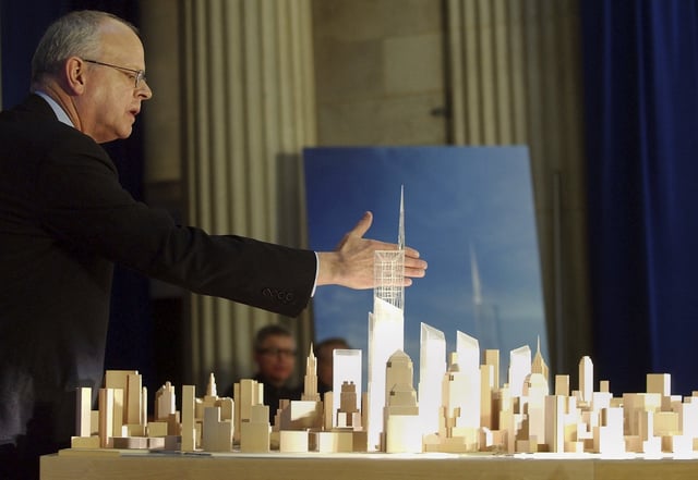 FILE - Architect David Childs puts his hand behind the top of the design for the Freedom Tower to be built on the World Trade Center site during an unveiling ceremony in Federal Hall, New York, Friday, Dec. 19, 2003. (AP Photo/Gregory Bull, file)