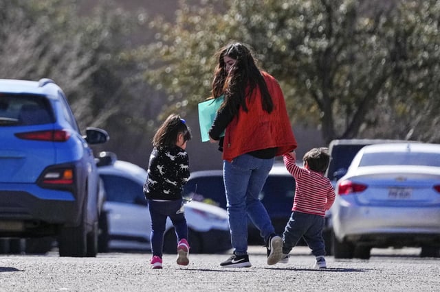 Jennifer Sanchez holds medical records as she walks with her children after she got vaccine appointments for them at the Ector County Health Department Monday, Feb. 24, 2025, in Odessa, Texas. 