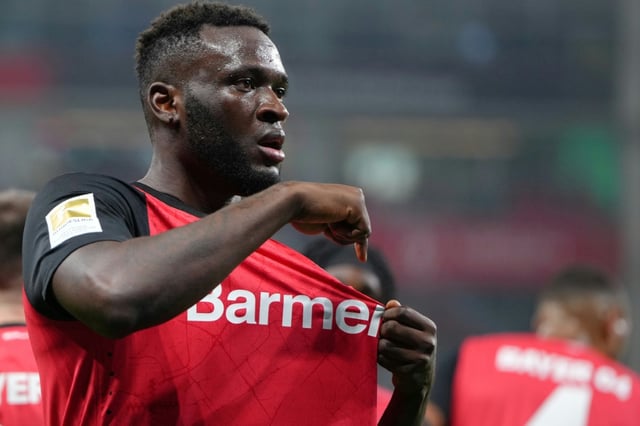 Bayer Leverkusen striker Victor Boniface points to the club's badge after scoring in Friday's 3-1 win over Bochum