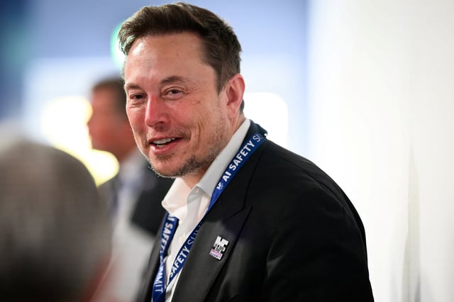 BLETCHLEY, ENGLAND - NOVEMBER 01: SpaceX, X (formerly known as Twitter), and Tesla CEO Elon Musk speaks with other delegates during day one of the AI Safety Summit at Bletchley Park on November 01, 2023 in Bletchley, England. Leon Neal/Pool via REUTERS/File Photo