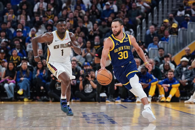SAN FRANCISCO, CA - APRIL 12: Stephen Curry #30 of the Golden State Warriors dribbles the ball up the court against Zion Williamson #1 of the New Orleans Pelicans at Chase Center on April 12, 2024 in San Francisco, California.