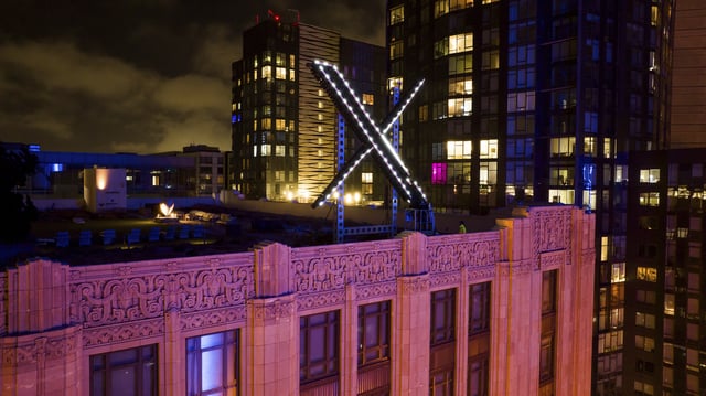 FILE - Workers install lighting on an "X" sign atop the company headquarters, formerly known as Twitter, in downtown San Francisco, July 28, 2023. (AP Photo/Noah Berger, File)