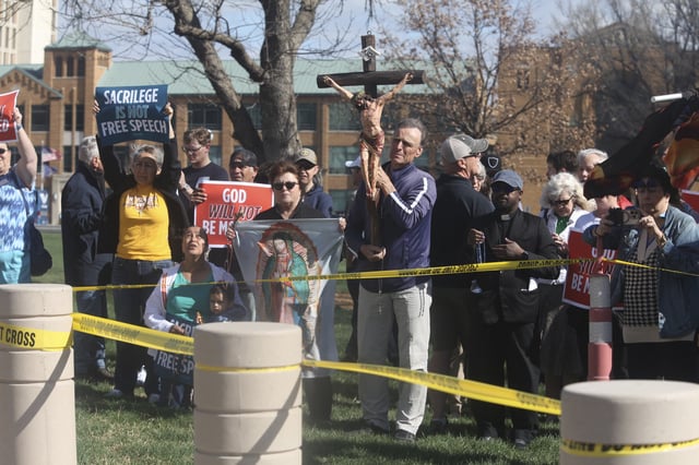 Roman Catholics are among the Christians counter-protesting at a rally by the Satanic Grotto from the Kansas City area outside the Kansas Statehouse, Friday, March 28, 2025, in Topeka, Kansas. (AP Photo/John Hanna)