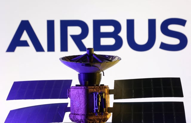 Airbus logo and miniature satellite model are seen in this illustration taken, March 10, 2025. REUTERS/Dado Ruvic/Illustration/File Photo