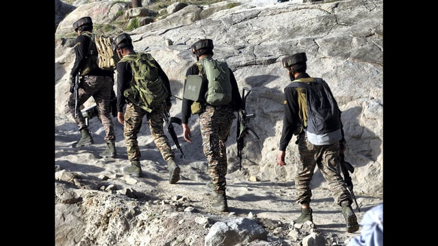 Security personnel patrol a remote forested area, in Kathua district, on Friday. (PTI)