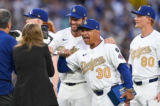 Dodgers pitcher Clayton Kershaw, center, and manager Dave Roberts (30) smile with their 2024 World Series championship rings during an on-field ceremony before their game against the Detroit Tigers on Friday night at Dodger Stadium. (Photo by David Crane, Los Angeles Daily News/SCNG)