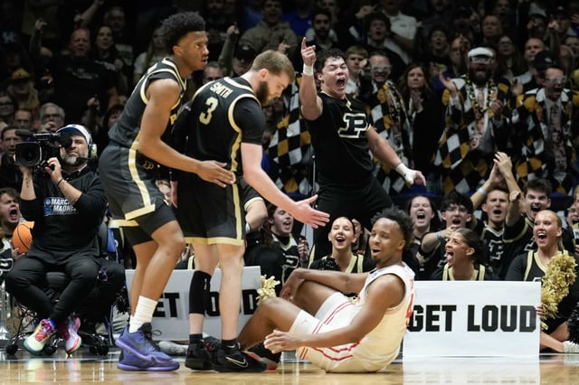 A Purdue cheerleader reacts after Houston guard L.J. Cryer (4) comes up short and Purdue guard Braden Smith (3) gestures to help him up during the first half of a Midwest Regional semifinal basketball game in the NCAA Tournament at Lucas Oil Stadium in Indianapolis, Friday, March 28, 2025.