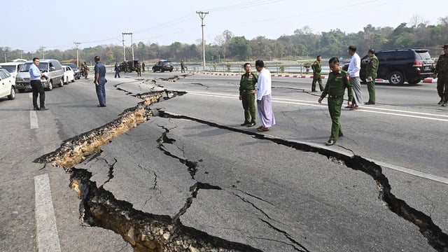 In this image provided by The Myanmar Military True News Information Team, Myanmar's military leader Senior Gen. Min Aung Hlaing, center, inspects damaged road caused by an earthquake Friday, in Naypyitaw.