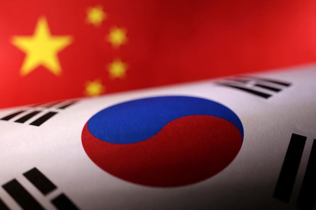 Printed Chinese and South Korean flags are seen in this illustration, July 21, 2022. REUTERS/Dado Ruvic/Illustration/File Photo