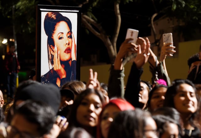 Fans carry a portrait of Selena Quintanilla-Pérez following the ceremony honoring her with a star on the Hollywood Walk of Fame in Los Angeles.
