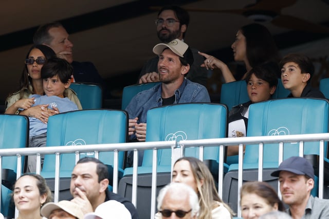 Mar 28, 2025; Miami, FL, USA; Inter Miami forward Lionel Messi (T-M) sits with his family in the stands during the match between Novak Djokovic (SRB) and Grigor Dmitrov (BUL)(both not pictured) in a men's singles semifinal on day eleven of the Miami Open at Hard Rock Stadium. Mandatory Credit: Geoff Burke-Imagn Images