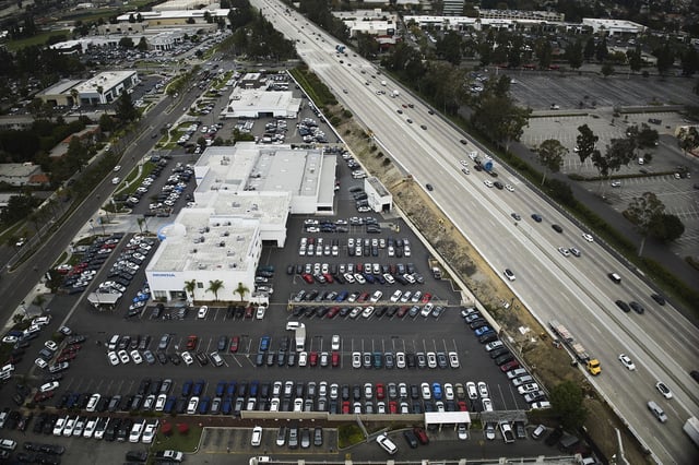 An aerial view shows auto dealerships in Cerritos, Calif., Thursday, March 27, 2025. (AP Photo/Jae C. Hong)