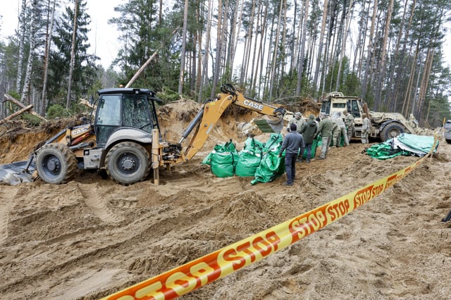 Military personnel work at the site of a recovery operation for missing U.S. soldiers at Pabrade training ground in Lithuania on March 28.