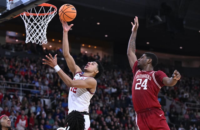 Mar 22, 2025; Providence, RI, USA; St. John's Red Storm guard RJ Luis Jr. (12) shoots against Arkansas Razorbacks forward Billy Richmond III (24) during the second half of a second round men’s NCAA Tournament game at Amica Mutual Pavilion. Mandatory Credit: Brian Fluharty-Imagn Images/File Photo