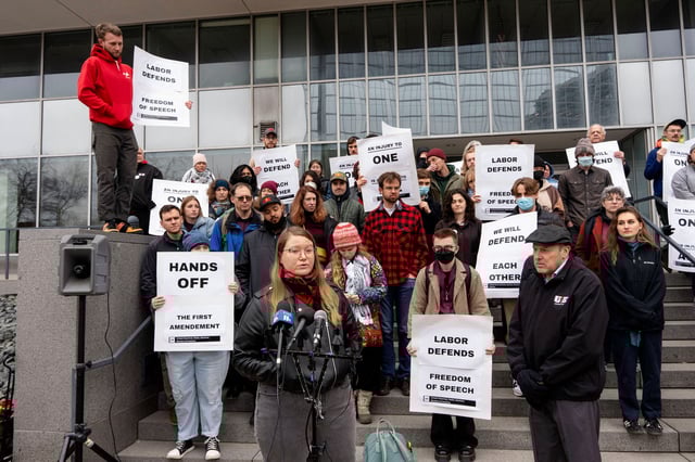 Protestors gather outside the Paul D. Wellstone Federal Building in Minneapolis after a University of Minnesota international graduate student was detained by US Immigration and Customs Enforcement agents.