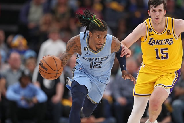 MEMPHIS, TENNESSEE - APRIL 26: Ja Morant #12 of the Memphis Grizzlies brings the ball upcourt against Austin Reaves #15 of the Los Angeles Lakers during Game Five of the Western Conference First Round Playoffs at FedExForum on April 26, 2023 in Memphis, Tennessee.