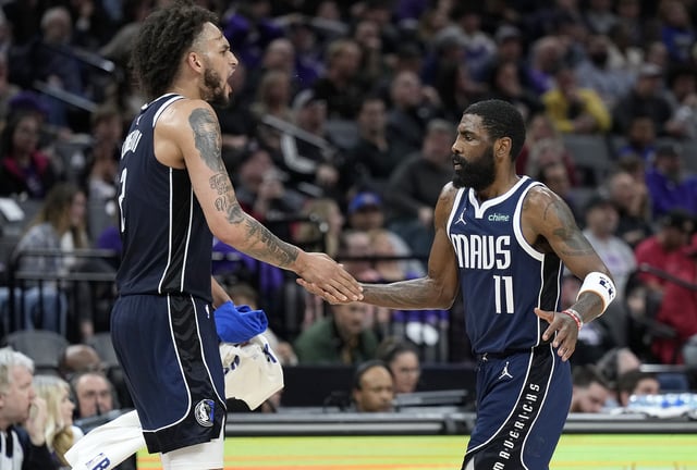 Kyrie Irving #11 of the Dallas Mavericks is congratulated by Dereck Lively II #2 after Irving scored against the Sacramento Kings during the second half of an NBA basketball game at Golden 1 Center on March 29, 2024 in Sacramento, California.