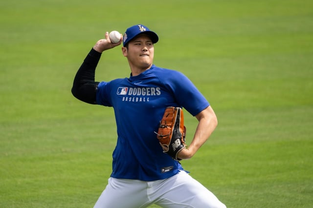 Dodgers star Shohei Ohtani throws in the outfield before their home opener against the Detroit Tigers on Thursday, March 27, 2025, at Dodger Stadium. (AP Photo/Kyusung Gong)