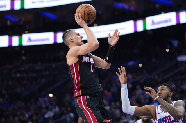 Miami Heat guard Tyler Herro goes up for a shot against Philadelphia 76ers&#39; Justin Edwards during the first half of an NBA basketball game Saturday, March 29, 2025, in Philadelphia. (AP Photo/Matt Slocum)