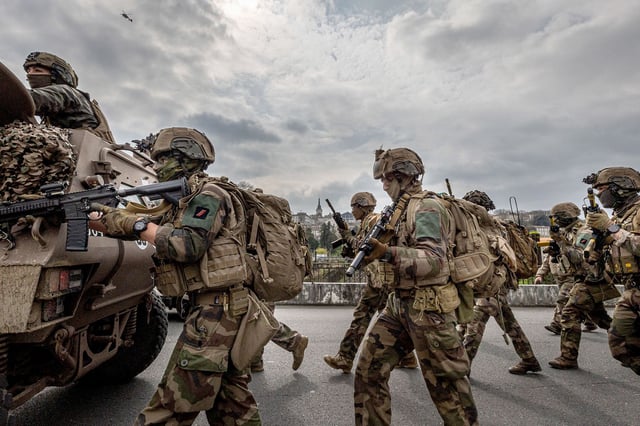 Under the overflight of a Gendarmerie helicopter, the assault column of the First Marine Infantry Regiment advances during the Balerit joint and combined military exercise at Angouleme in the Charente department in the Nouvelle Aquitaine region of western France, on March 26, 2025. (Photo by Romuald Goudeau / Hans Lucas / Hans Lucas via AFP) (Photo by ROMUALD GOUDEAU/Hans Lucas/AFP via Getty Images)          