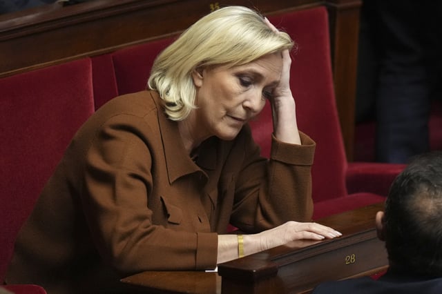 FILE - French far-right leader Marine Le Pen reacts at the National Assembly before French Prime Minister Francois Bayrou delivers his general policy speech meant to outline his top priorities, Tuesday, Jan. 14, 2025 in Paris. (AP Photo/Thibault Camus, File)