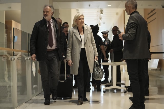 FILE - French far-right leader Marine Le Pen arrives with her legal team at the court house in Paris, Sept. 30, 2024. (AP Photo/Thibault Camus, File)