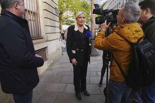 FILE - French far-right leader Marine Le Pen answers to the media during a gathering in support of detained Franco-Algerian writer Boualem Sansal, in Paris, Tuesday, March 25, 2025. (AP Photo/Thibault Camus, File)